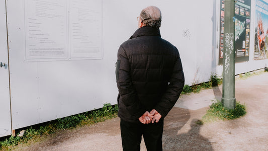 a man standing in front of a white wall