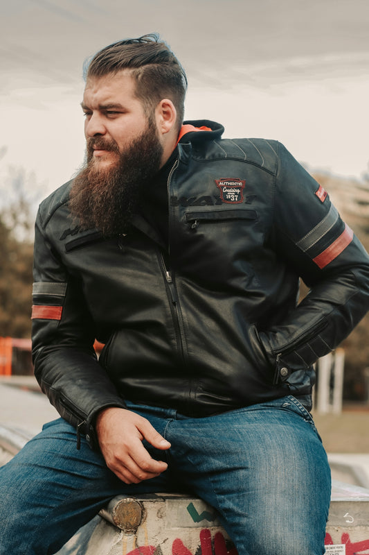 a man with a beard sitting on a wall