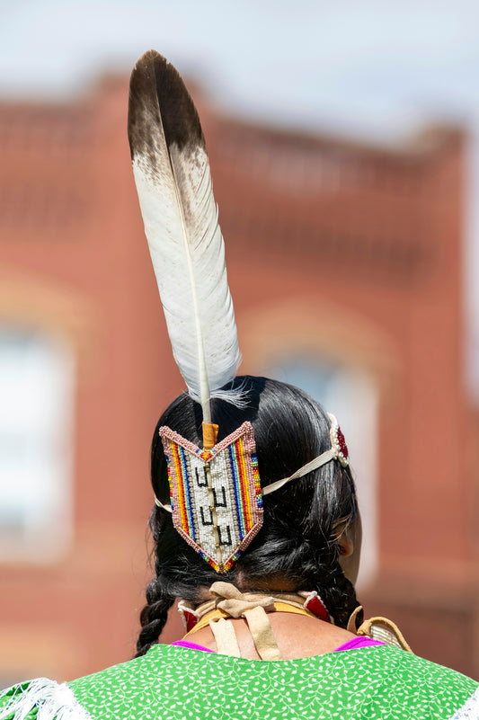 a woman with a feather on her head
