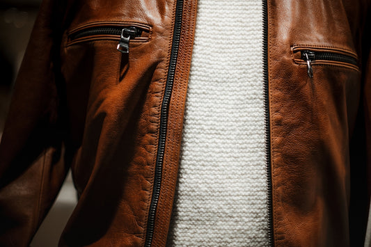 a close up of a person wearing a brown leather jacket