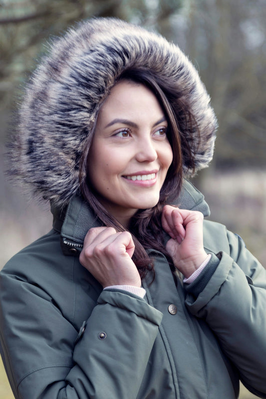 A woman in a parka with a hood on
