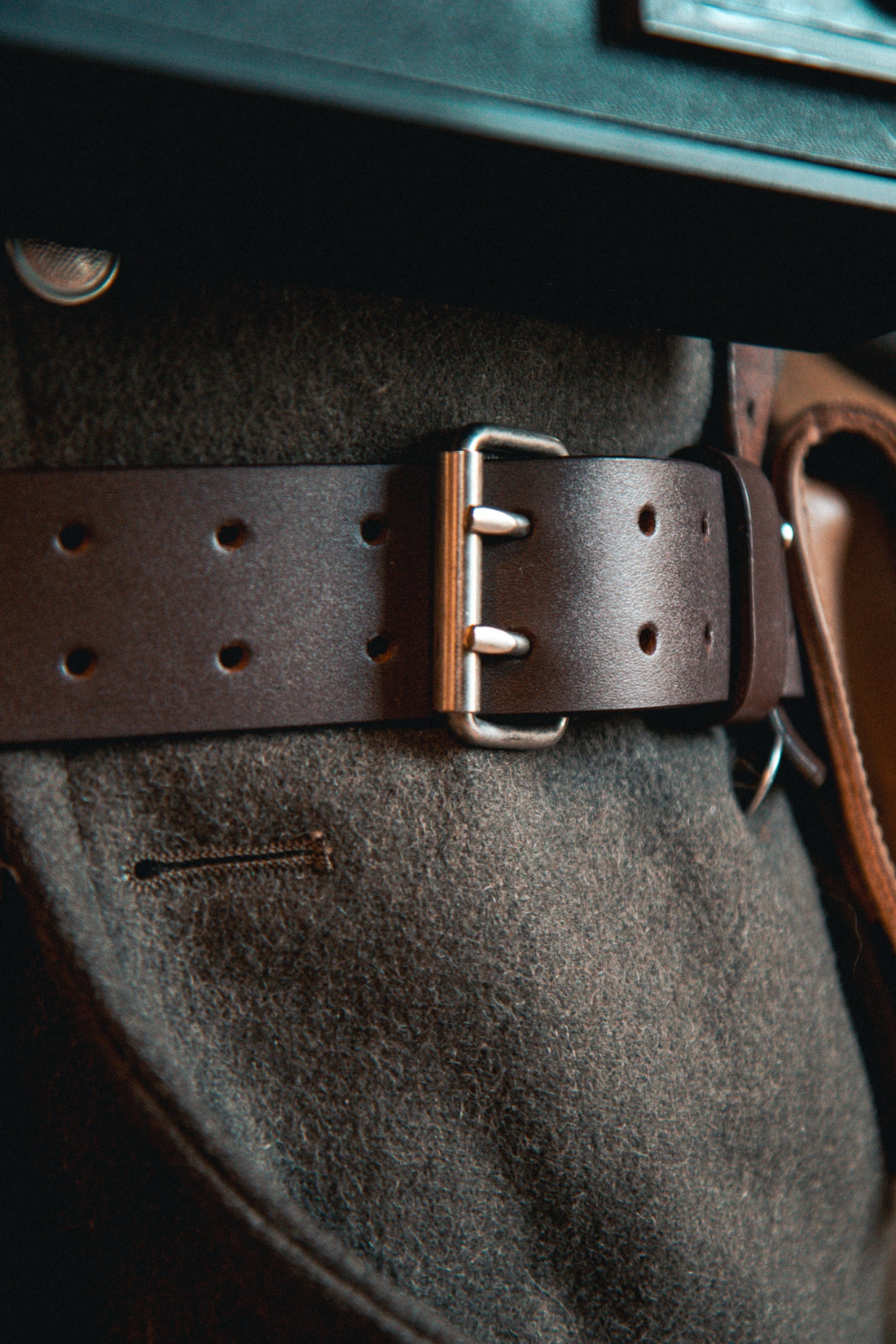 A close up of a brown leather belt