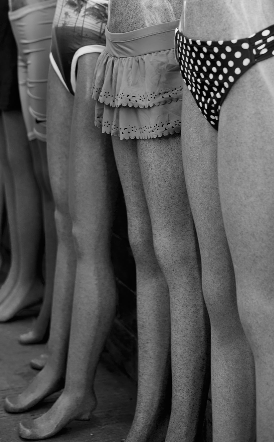 Row of people in swimsuits standing side by side