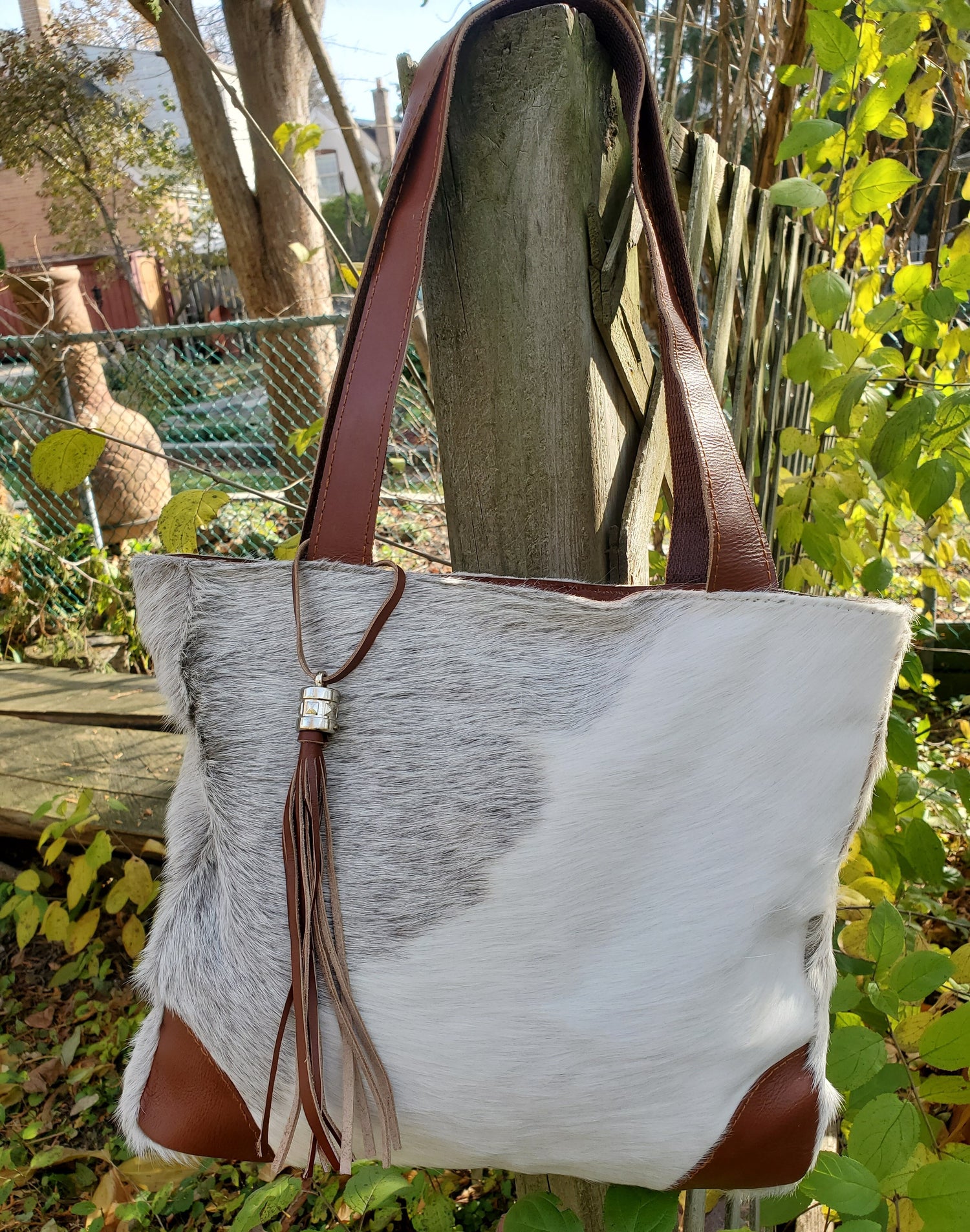 Cowhide tote bag that will be love at first sight, well made, comes with add-on features, premium strap, zipper and pocket for accessories