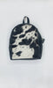 Classic cowhide backpack ideal for everyday use, offering versatility and sophistication for any occasion or setting.