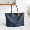 Real cowhide leather tote with top handle and zipper, offering a clean, organized layout for women’s work and travel needs.