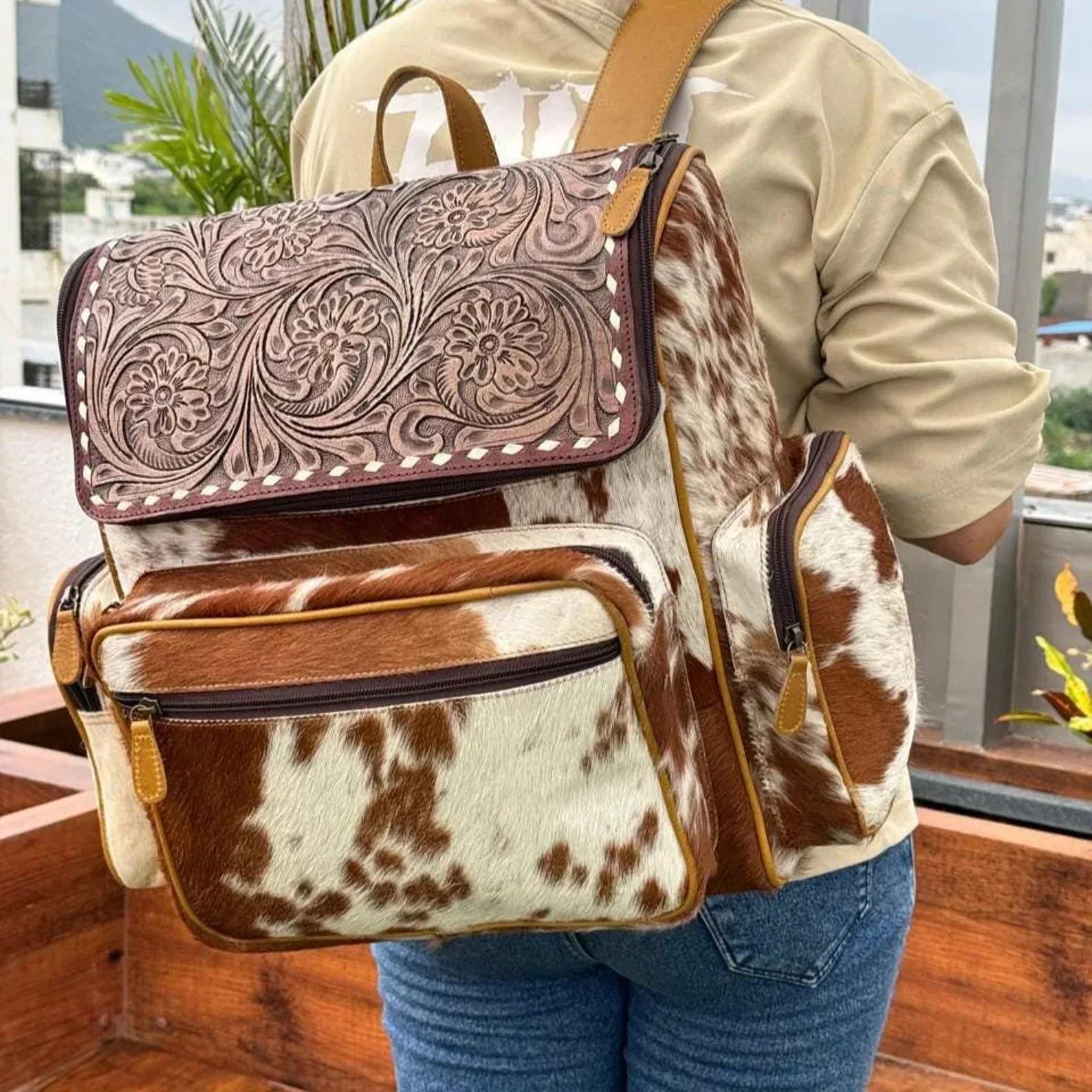 Tooled hair-on cowhide backpack with floral flap
