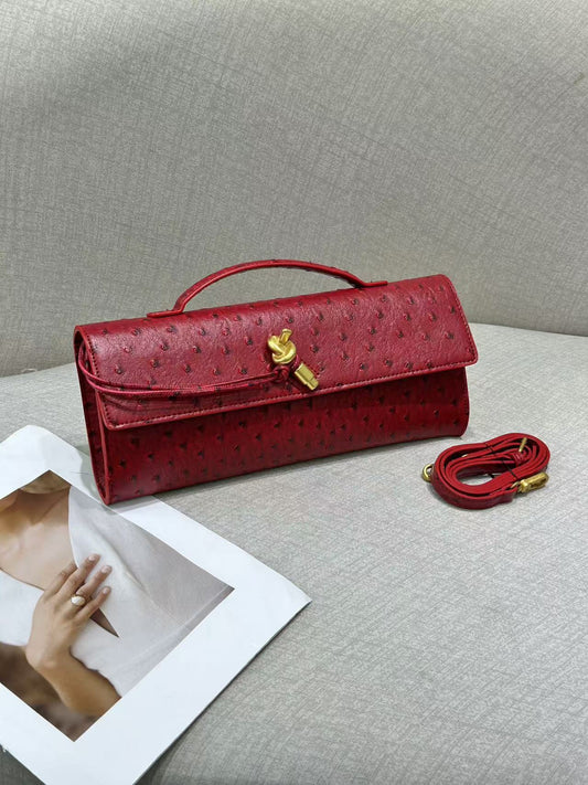 Women’s leather handbag in genuine cowhide with ostrich pattern finish, gold lock closure, and detachable strap for clutch or crossbody use.