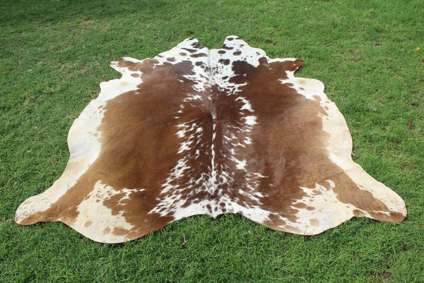 Enhance your space with our unique collection of brown and white cowhide rugs, perfect for adding a touch of natural elegance to any room.