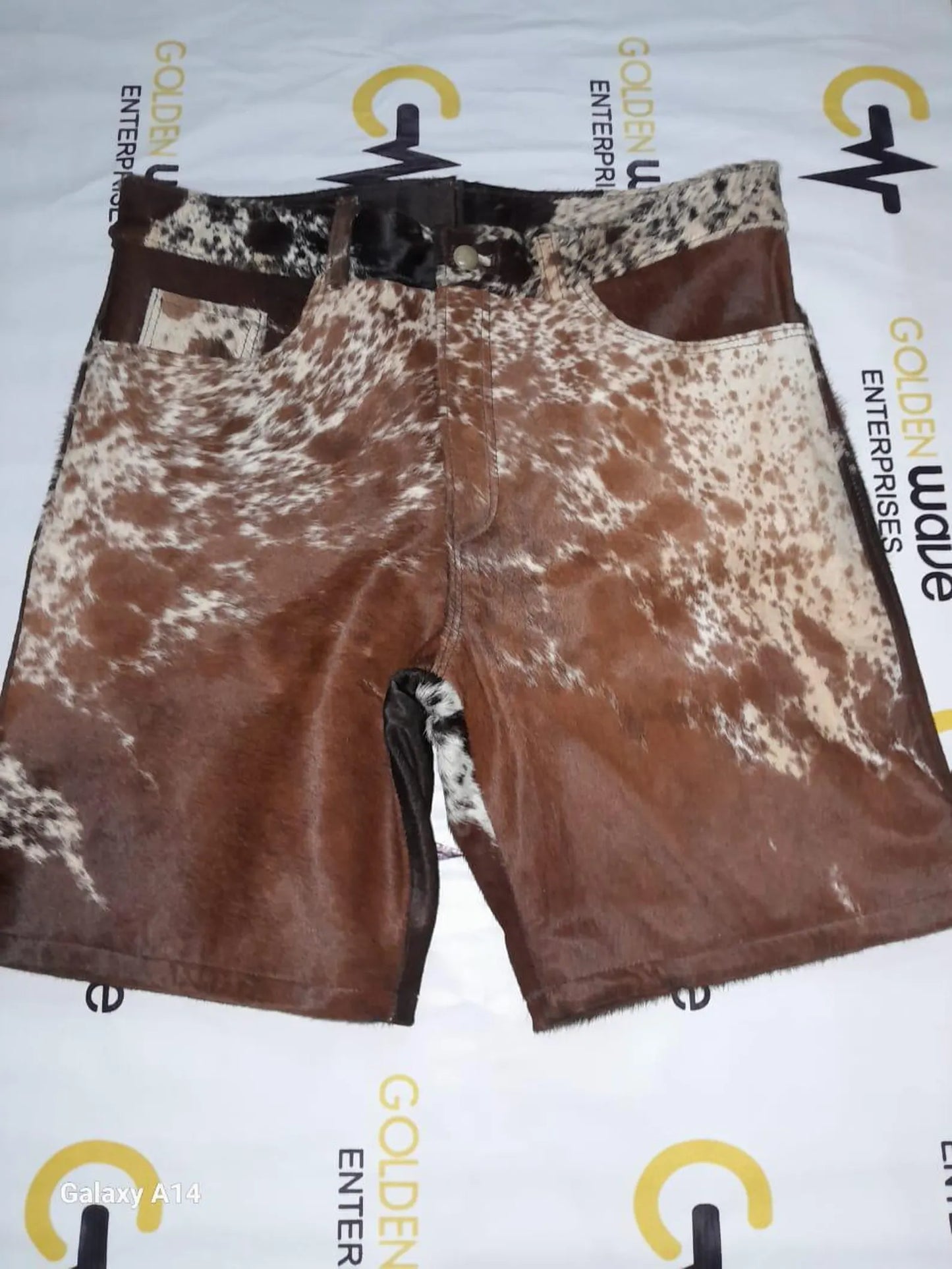 Real cowhide shorts in tricolor cow print made for western wear, rodeo events, and cowgirl or cowboy outfits. Each cow skin short has its own bold pattern.

