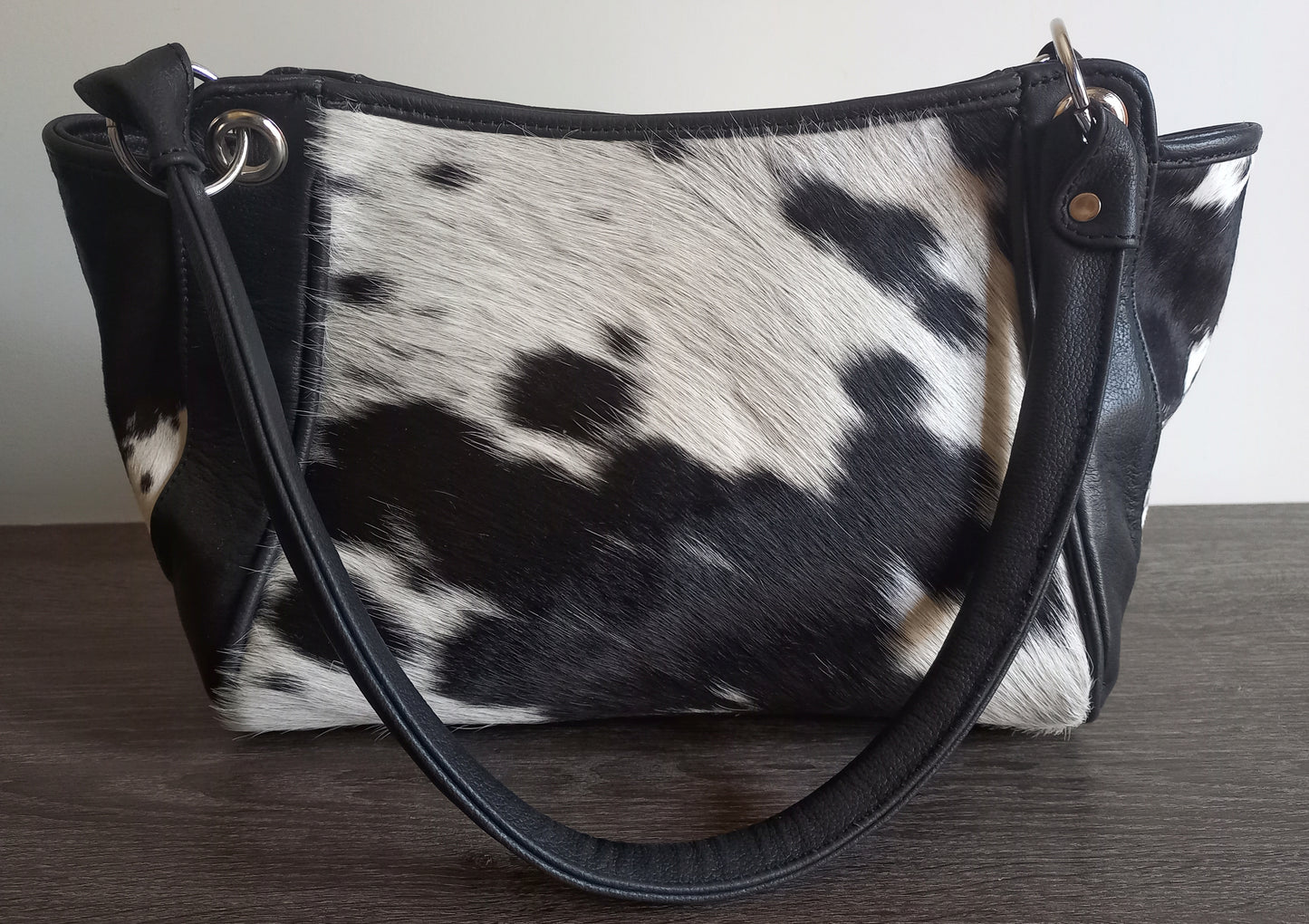 Black and white cowhide shoulder purse