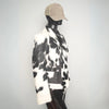 Black and white cowhide fur coat with natural hide pattern. Warm western jacket for rodeo styling, ranch wear, and unisex winter country fashion.