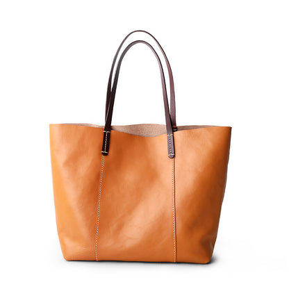 Genuine leather tote bag for women featuring zipper closure, deep interior, and minimalist shape for work, meetings, and daily carry.

