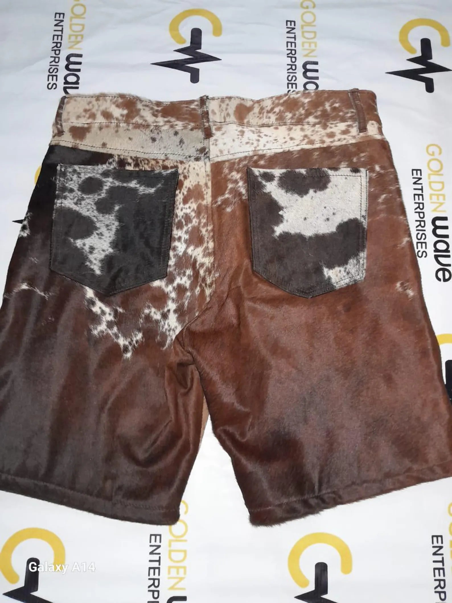 Genuine cow skin shorts in tricolor hide pattern for men and women. Designed for rodeo, country events, and western fashion fans who want a standout cow print.

