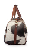 Discover elegance with a cow fur overnight bag, your essential travel accessory for luxurious adventures.