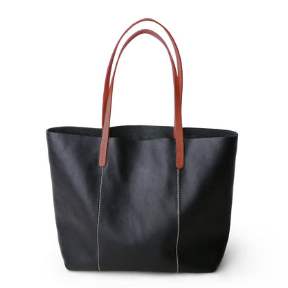 Structured full grain leather tote with laptop compartment, designed for women needing a spacious, professional shoulder bag.

