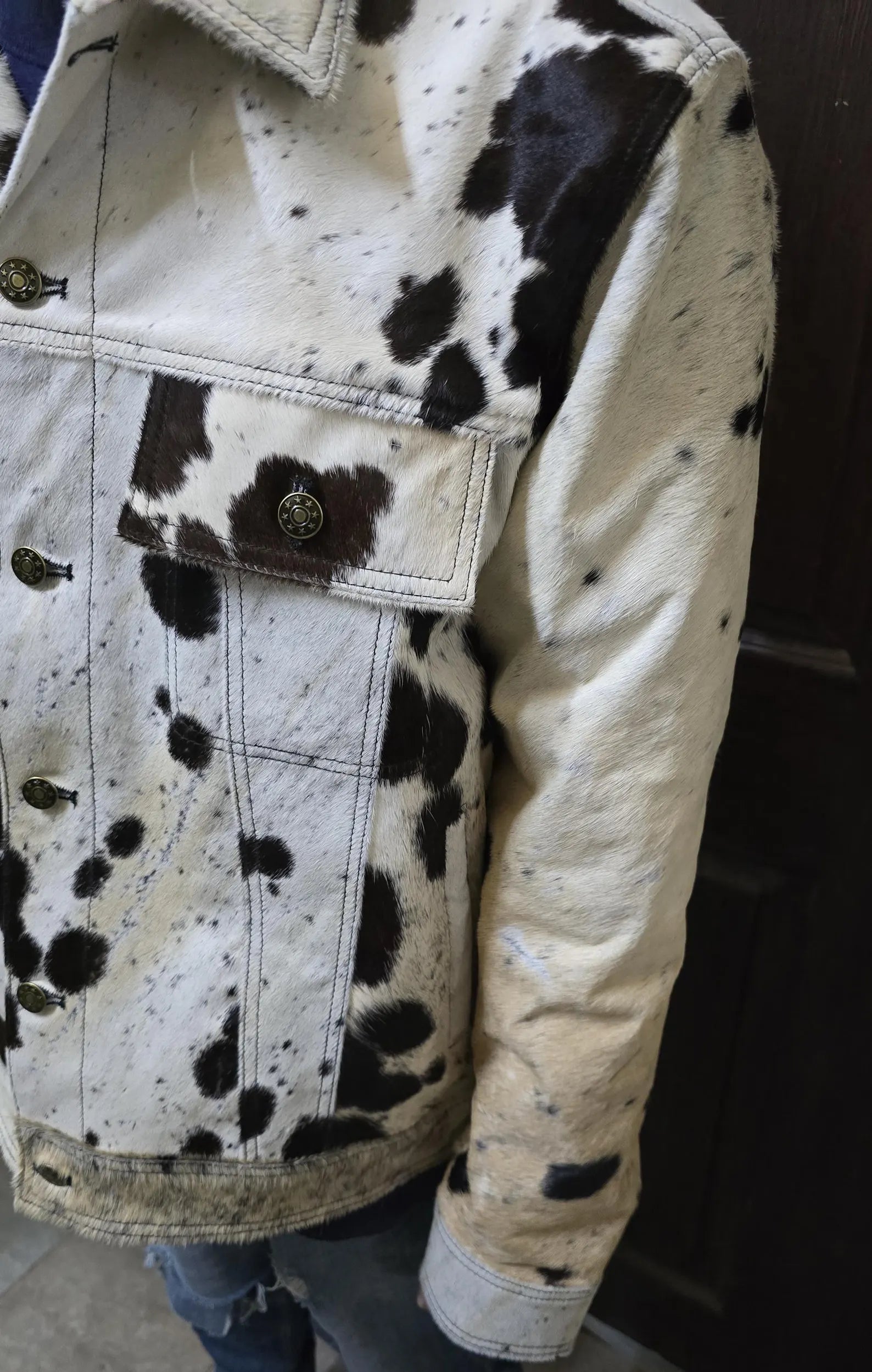 Real cowhide fur jacket for men in a tricolor cow pattern. Tailored cowboy coat designed for rodeo events, ranch fashion, and cow print lovers.