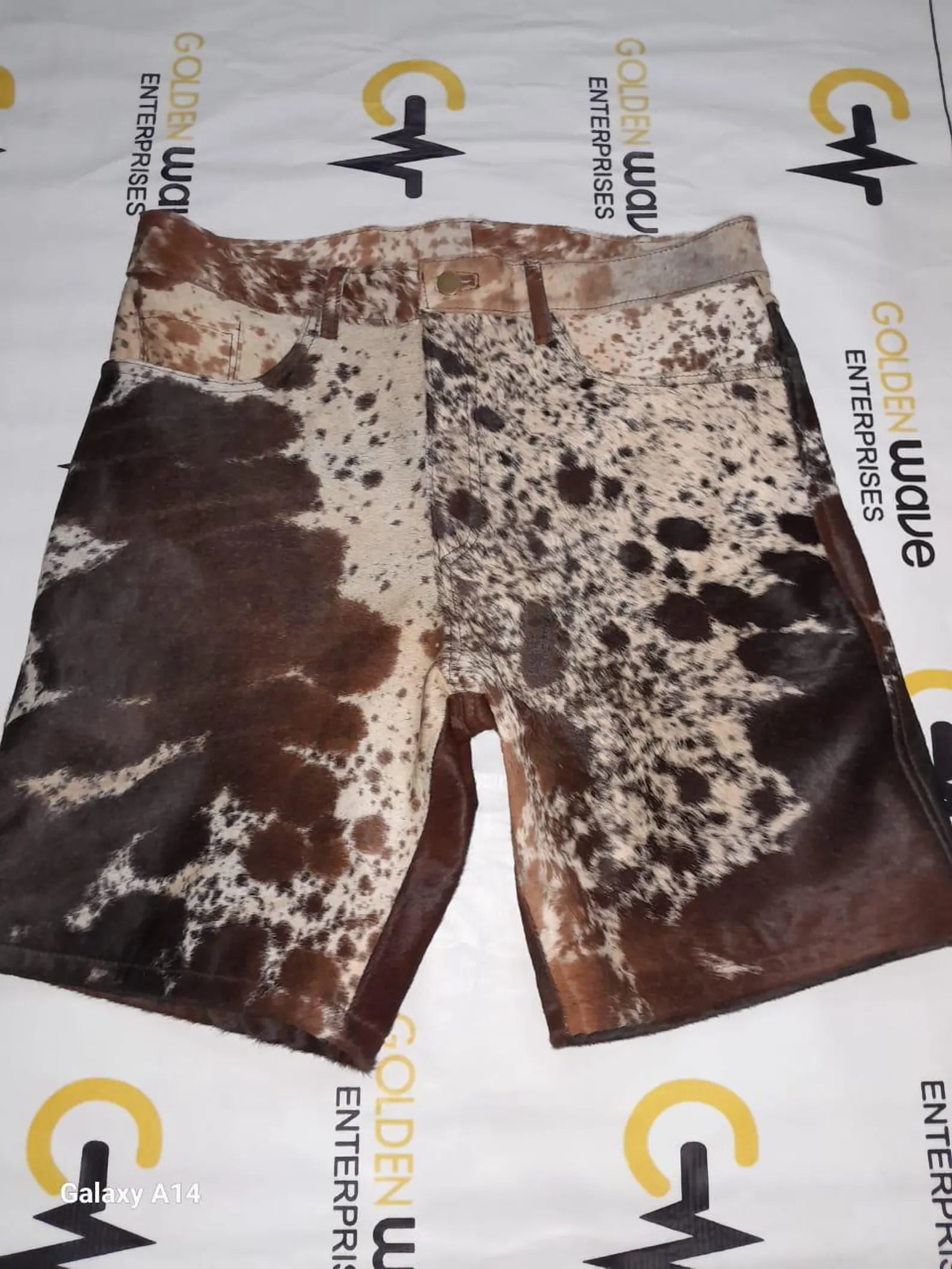 Handmade cowhide shorts with bold tricolor patterns. Real cow skin design for men or women outfits, western-themed occasions, and ranch-style looks.

