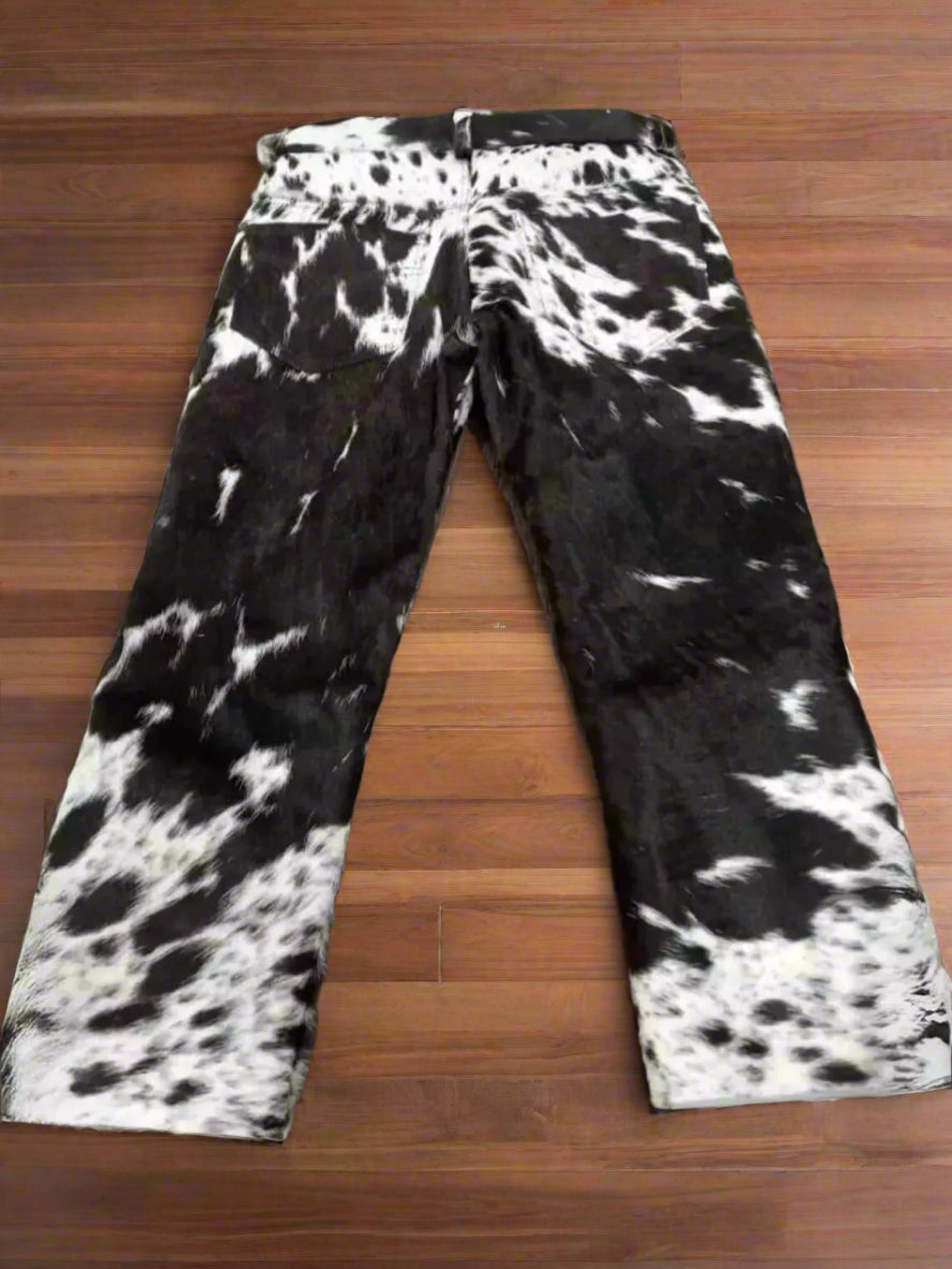 Real cowhide trousers featuring black and white patterns with natural calf hair. Shop unique cow fur trousers ideal for ranch wear, rodeo life, or western events.