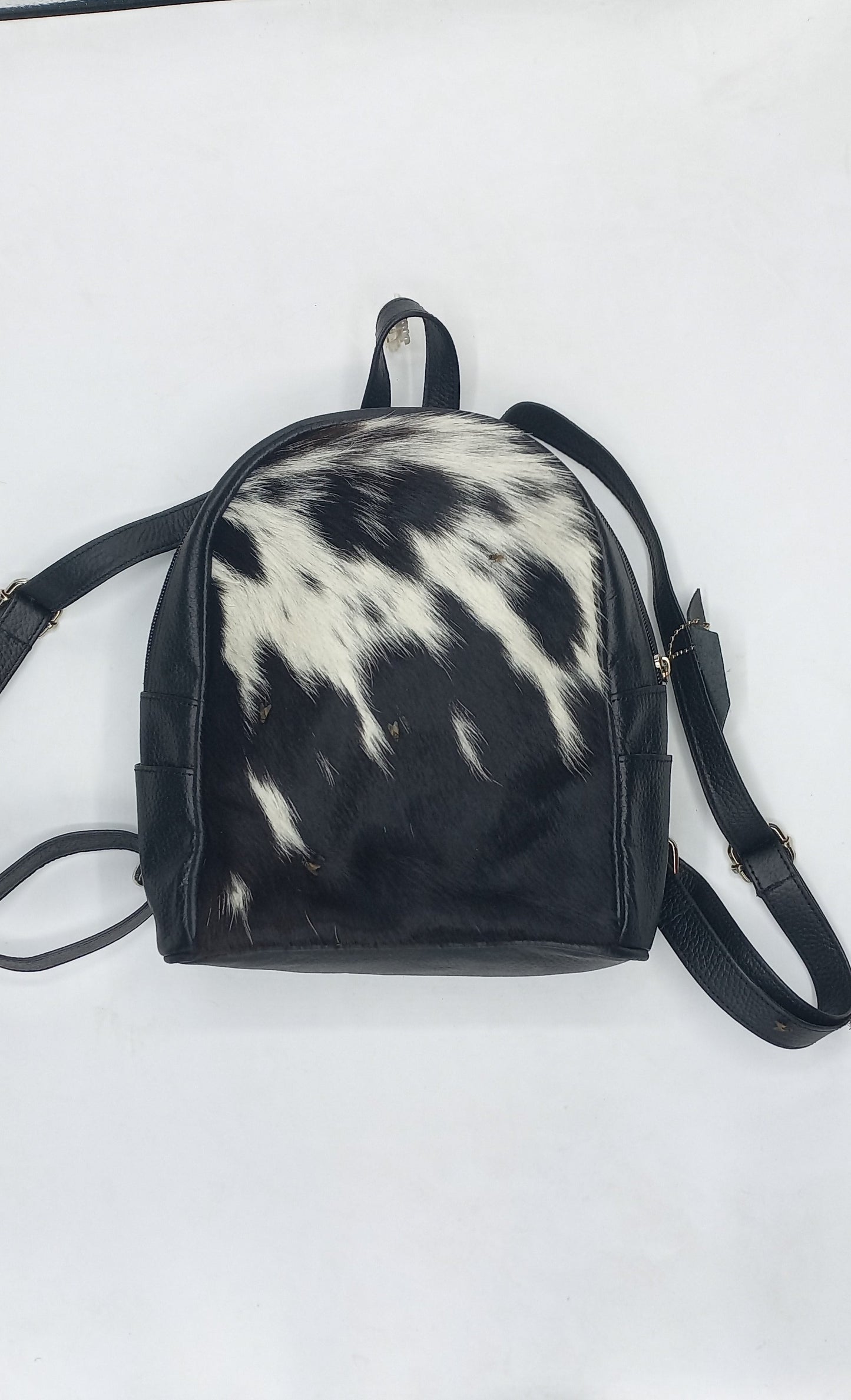 Stylish cow skin backpack featuring a spacious interior, making it ideal for carrying essentials while exuding urban flair.