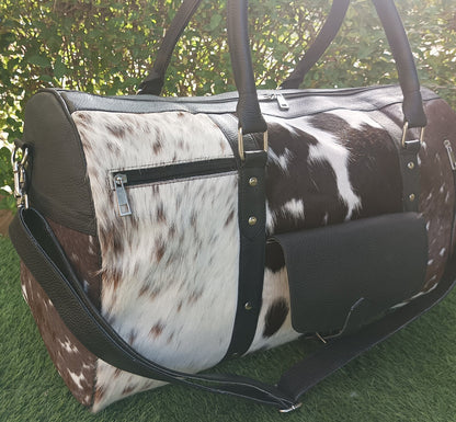 Experience the thrill of adventure with this cow skin weekender bag, crafted for the modern explorer.