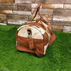 Discover new horizons with this cowhide travel bag, meticulously designed to cater to your travel needs.