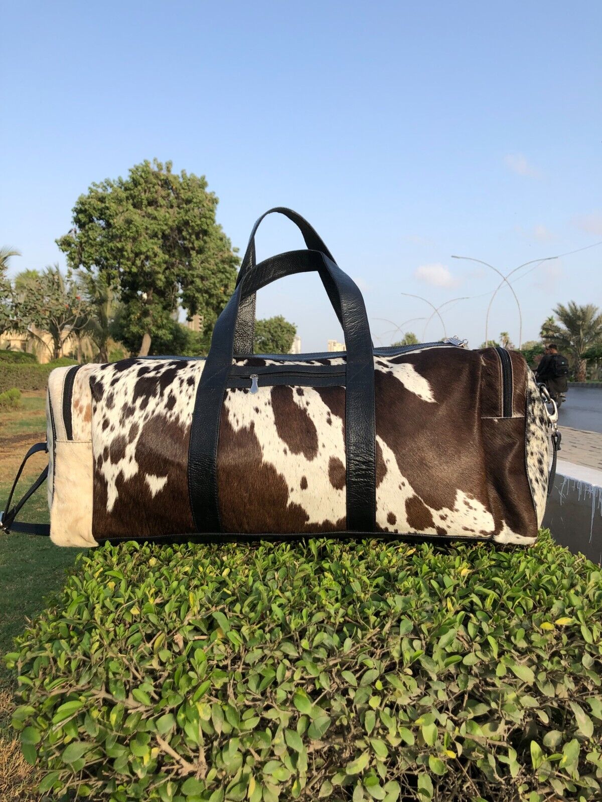 Experience luxury on-the-go with a refined cow fur duffle bag, your perfect companion for global adventures.