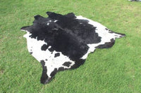 Create a luxurious ambiance with a black and white cowhide rug. Its plush texture provides warmth and comfort underfoot.