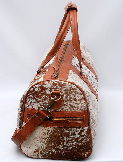 Unleash your wanderlust with this cowhide travel bag, a blend of rugged charm and urban sophistication.