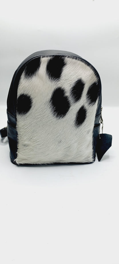 Trendy cow fur backpack perfect for urban adventures, combining fashion-forward design with the natural beauty of cowhide.