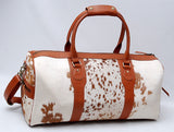 Experience the allure of adventure with this cowhide duffle bag, your passport to exploration.