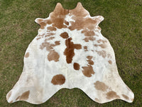 Transform your living space into a cozy retreat by adding one of our premium-quality brown and white cowhide rugs, featuring a blend of rich tones that effortlessly complement any decor.
