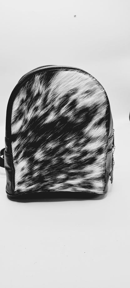 Chic cowhide backpack with multiple compartments for organization, offering both functionality and fashion in one sleek package.