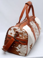 Radiate confidence on your travels with this cowhide travel bag, a symbol of understated luxury.