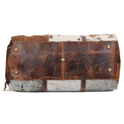 Experience luxury on-the-go with this cowhide weekender bag, designed to complement your jet-setting lifestyle.