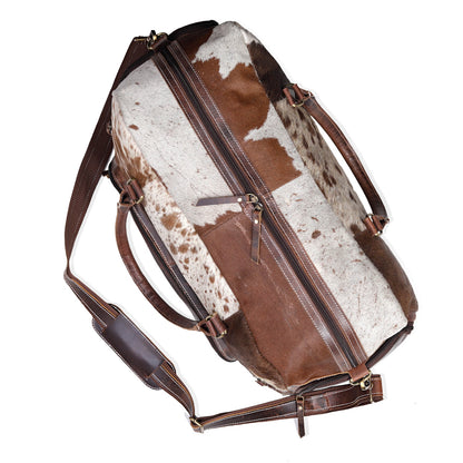 Experience luxury travel with this cow skin weekender bag, crafted for your adventures.