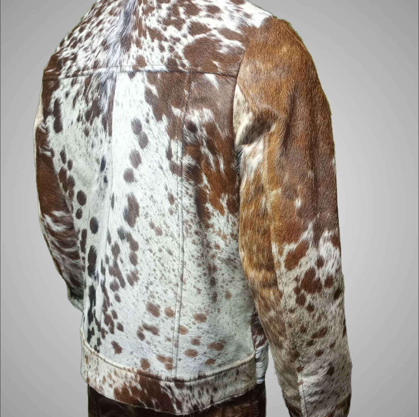 Cow print fur jacket crafted from genuine hide. Features visible cow fur texture, full-button front, and functional patch pockets — a standout western cowhide jacket.

