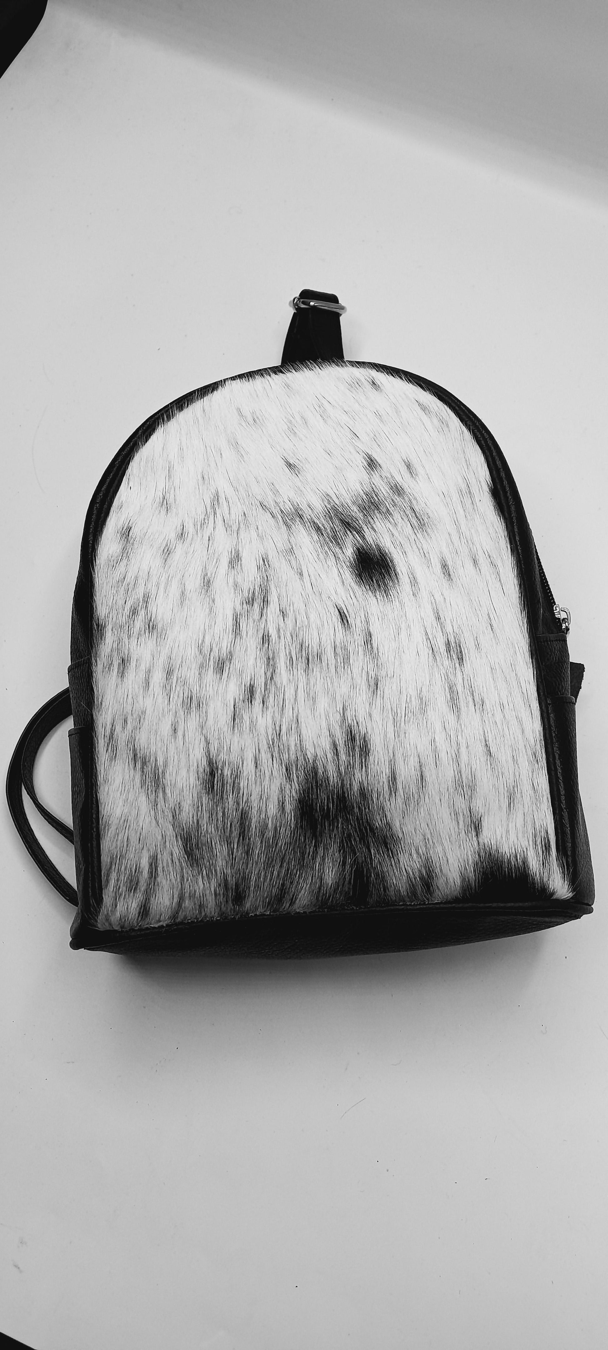  Luxurious cow fur backpack with a timeless design, ideal for those seeking a blend of elegance and practicality in their everyday carry.