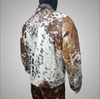 Men’s cowhide fur coat made from brown, white, and black cow print skin. Real hide jacket with a rugged look, designed for cowboy events and rustic menswear edits.


