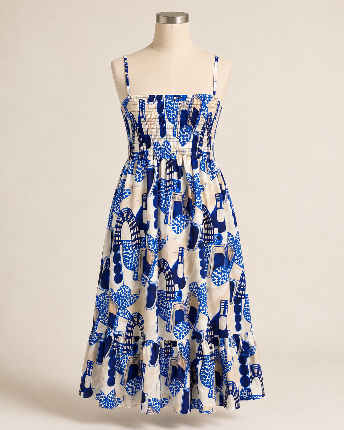 Abstract print summer dress with practical side pockets, a full skirt, and a wide gathered lower tier.