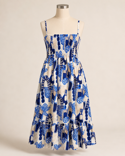 Abstract print summer dress with practical side pockets, a full skirt, and a wide gathered lower tier.