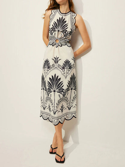 Blue palm print summer dress with a white background, side pockets and ornamental borders.