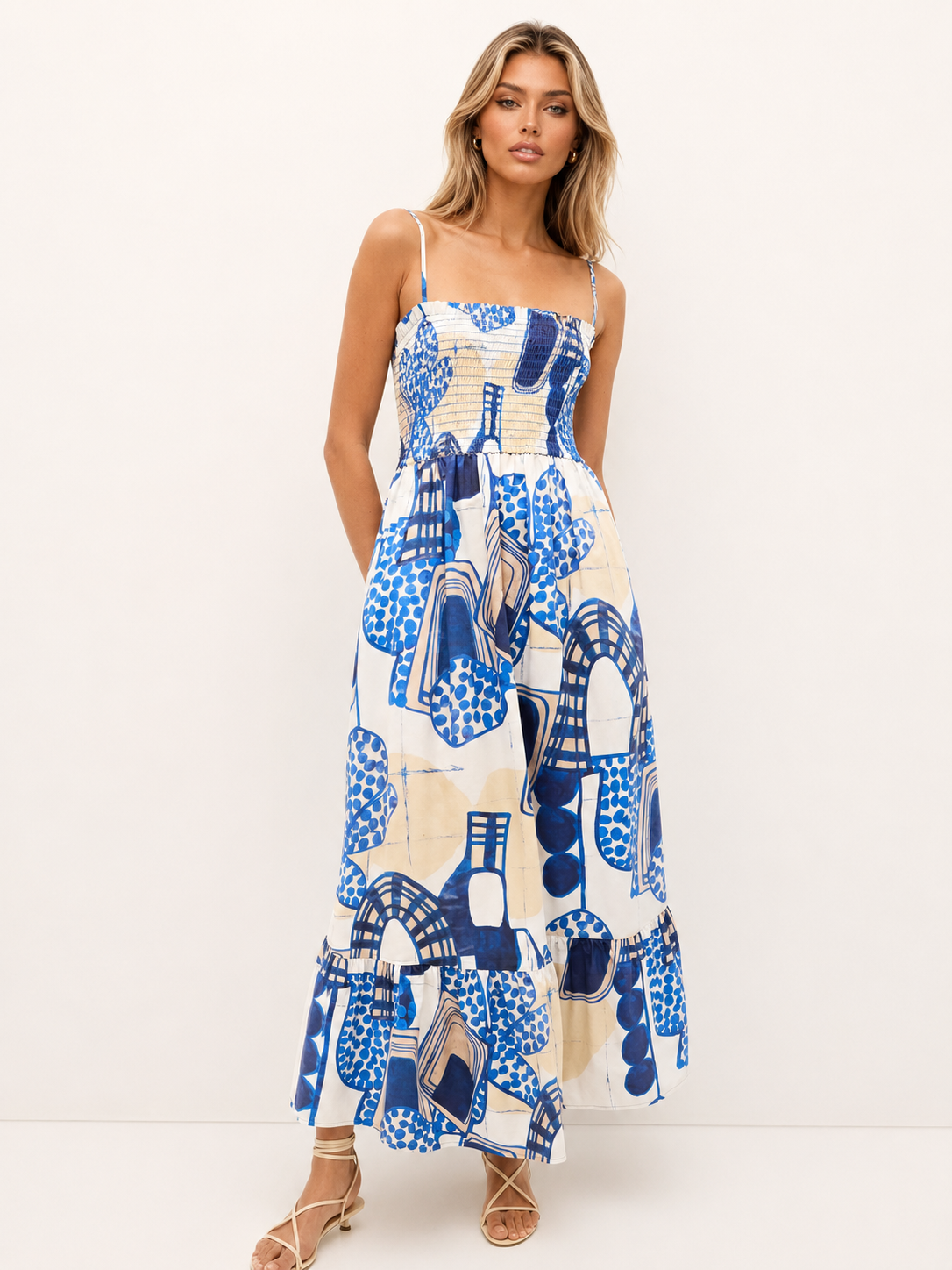 Summer maxi dress with a straight neckline, adjustable spaghetti straps, and bold cobalt blue motifs.