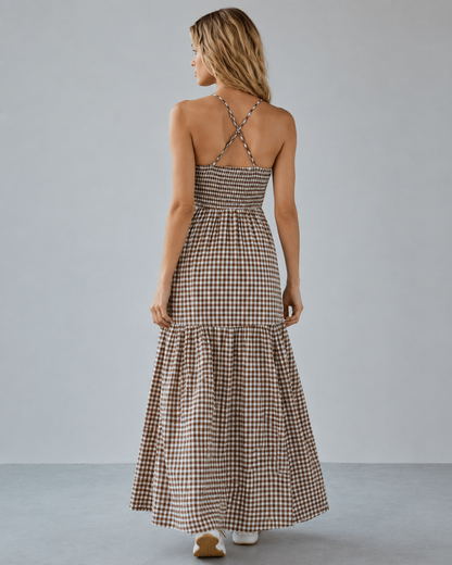  Brown gingham smocked maxi dress with a V-neck, fitted waist and flowing tiered skirt.