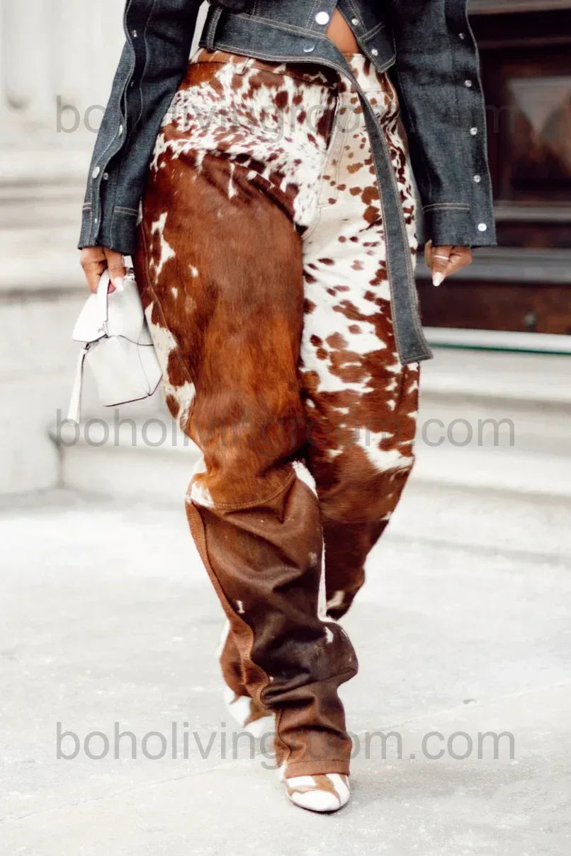 Brown and white cow print pants created from real cowhide rather than printed fabric with unique natural markings.