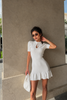 Cream knit mini dress with keyhole neck and ruffle hem