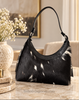 Cowhide purse with natural black-dominant hide pattern, soft white markings, curved body, and metal-tone strap hardware.