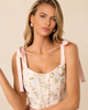 Corset top with floral print tie straps and lace up back