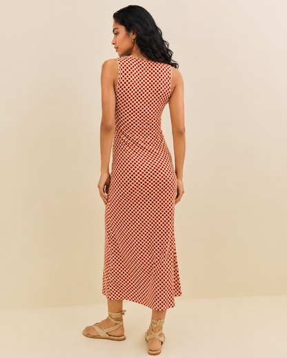 Fitted polka dot summer dress with a cream background and gently widened lower skirt.