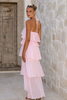 Floral halter evening dress with coral botanical motifs and tiered ruffle panels.